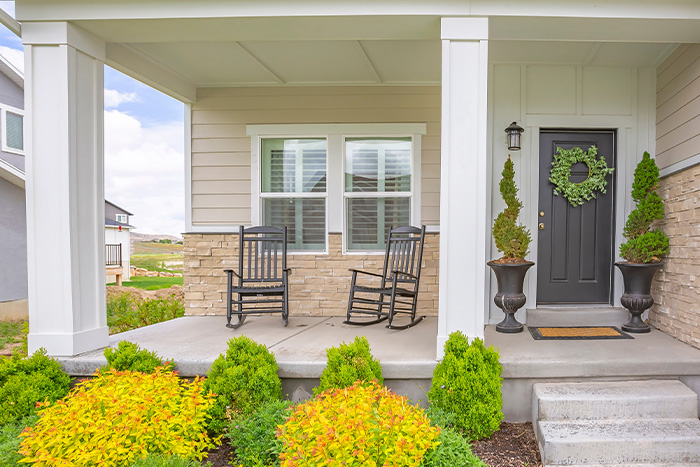 Front porch with two rocking chairs and decorative columns